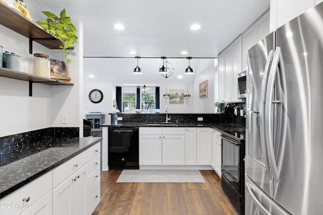 kitchen featuring sink, black appliances, white cabinetry, and dark stone countertops