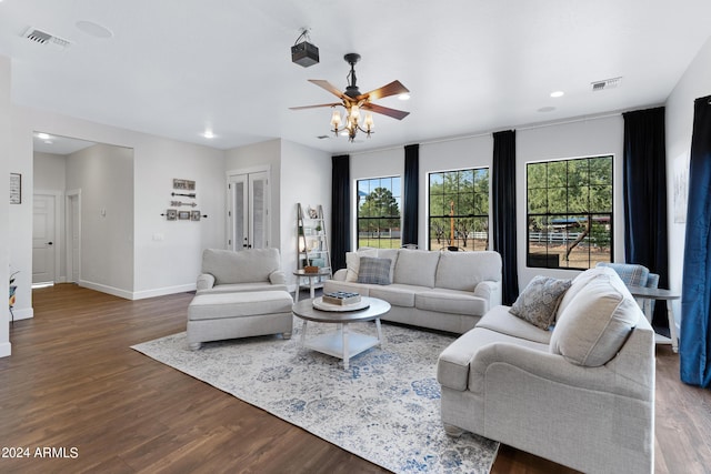 living room with dark hardwood / wood-style floors and ceiling fan