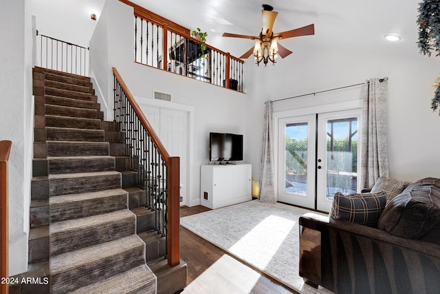 living room with ceiling fan, hardwood / wood-style floors, french doors, and vaulted ceiling