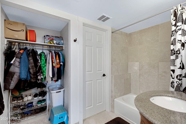 bathroom featuring vanity and shower / bath combo