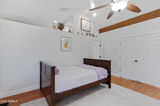 bedroom featuring a closet, ceiling fan, vaulted ceiling with beams, and hardwood / wood-style flooring