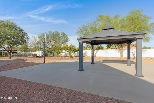 view of patio / terrace featuring a gazebo and basketball hoop