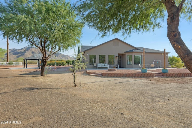 view of front of home with a patio area, a mountain view, a gazebo, and outdoor lounge area