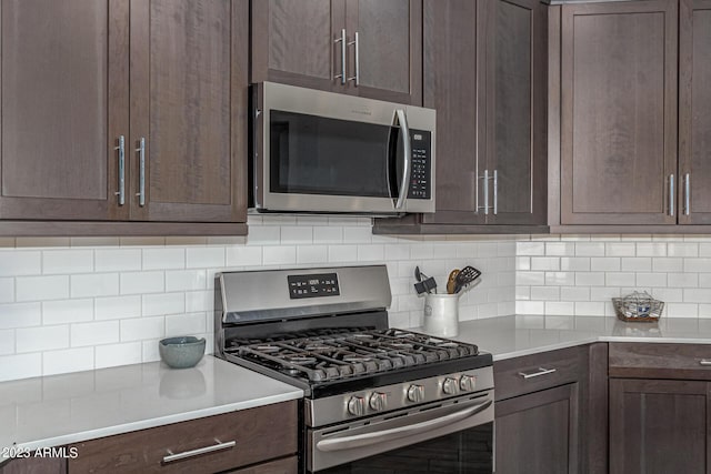 kitchen featuring stainless steel appliances, backsplash, and dark brown cabinetry