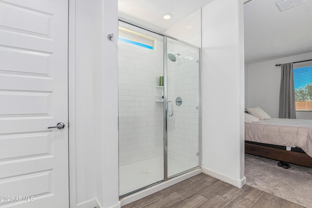 bathroom with a shower with shower door