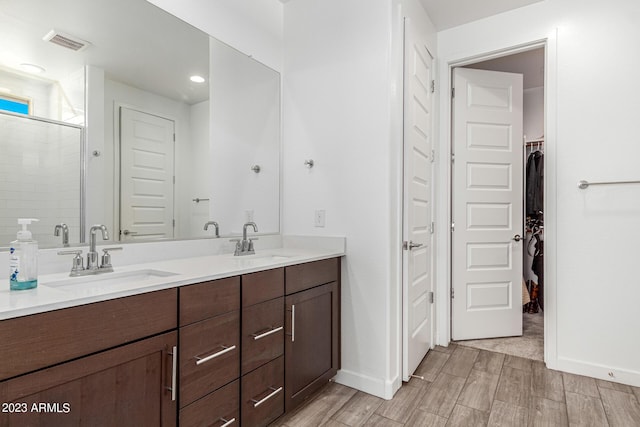 bathroom featuring vanity and an enclosed shower