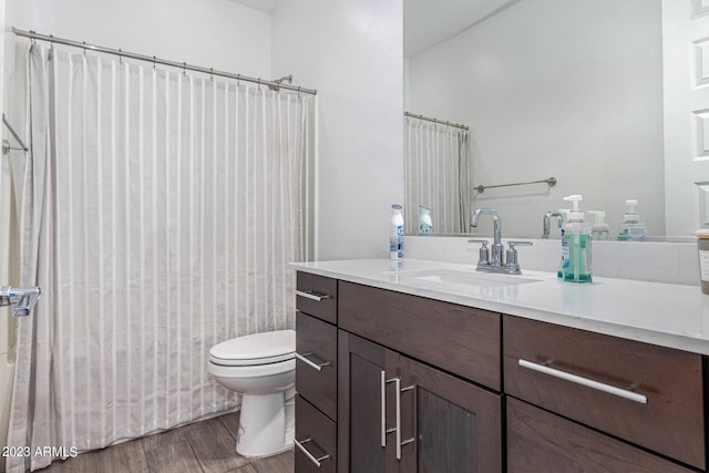 bathroom with vanity, hardwood / wood-style floors, and toilet