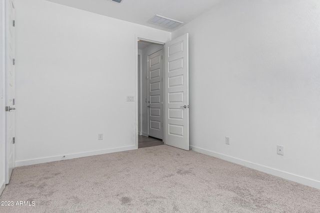 unfurnished bedroom featuring light carpet