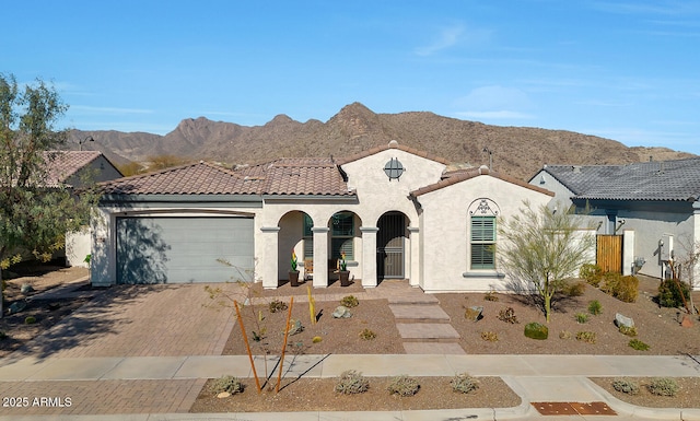 view of front facade with a garage and a mountain view