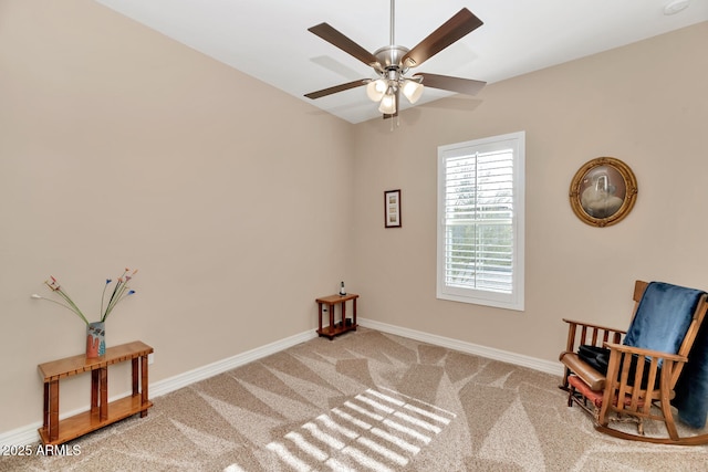 living area featuring carpet floors and ceiling fan