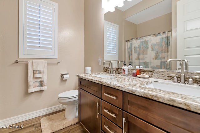 bathroom with vanity, hardwood / wood-style floors, curtained shower, and toilet