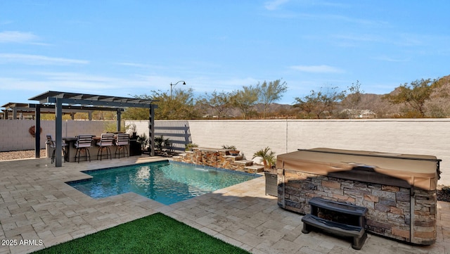 view of swimming pool with a bar, pool water feature, a pergola, a hot tub, and a patio area