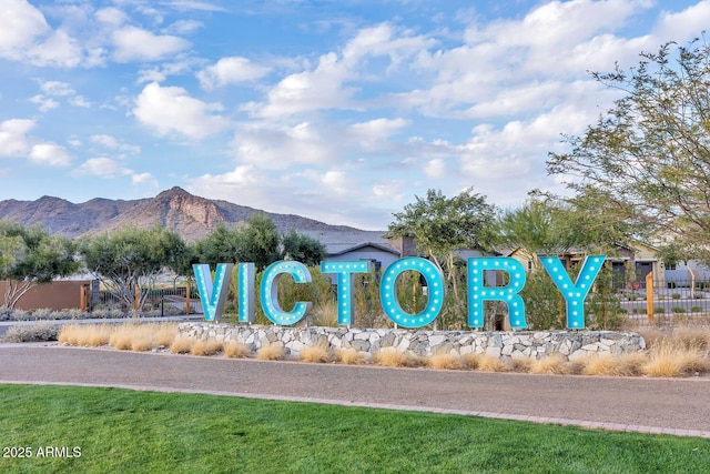 community sign with a mountain view