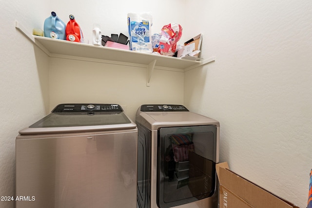 clothes washing area featuring separate washer and dryer