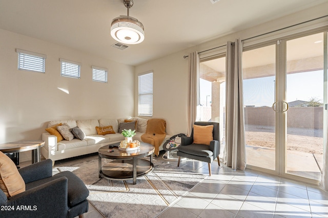 living room featuring french doors, light tile patterned floors, and plenty of natural light