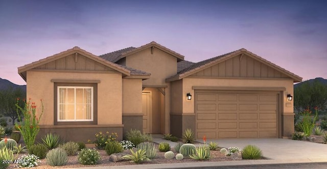 view of front of home with a garage, a tile roof, driveway, and stucco siding