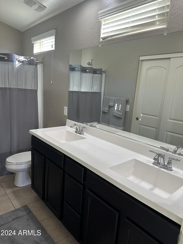 bathroom with toilet, vanity, tile patterned floors, and curtained shower