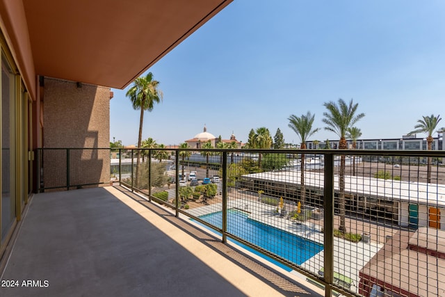 balcony featuring a community pool