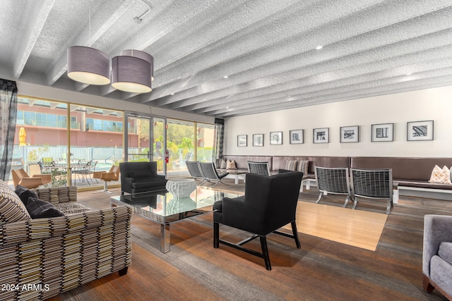 living room with a textured ceiling and hardwood / wood-style flooring