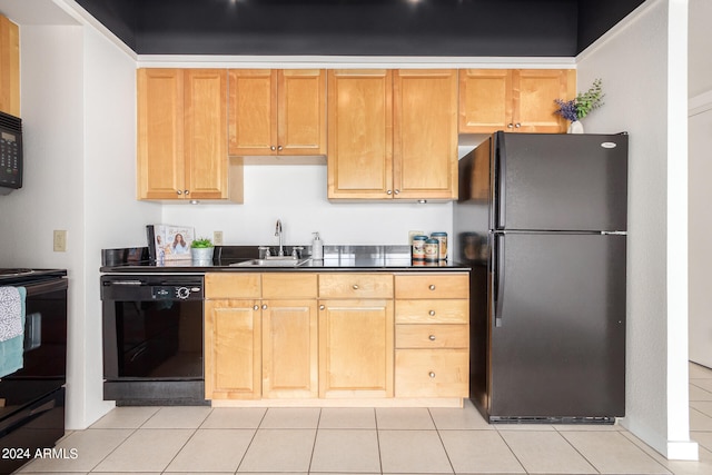 kitchen with black appliances, sink, and light tile patterned floors