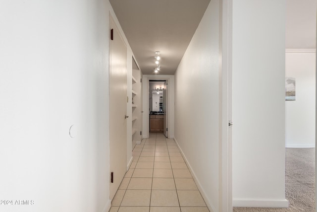 corridor with light tile patterned flooring