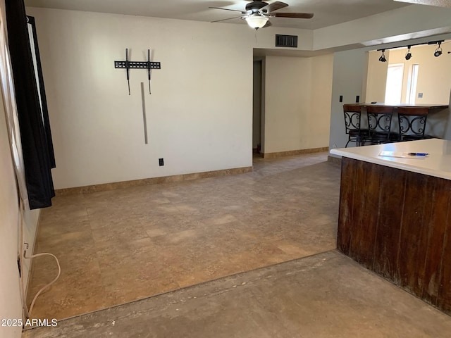 kitchen with dark brown cabinetry and ceiling fan