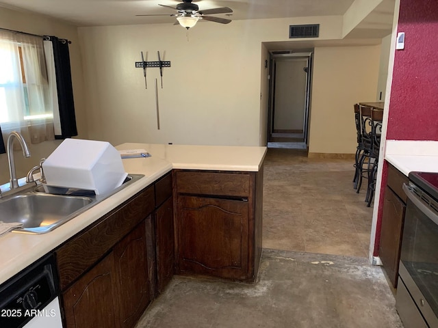 kitchen featuring ceiling fan, dark brown cabinets, white dishwasher, and sink