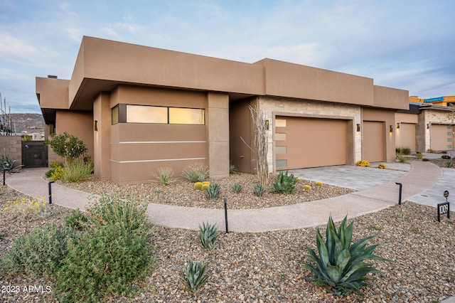 pueblo-style house featuring a garage