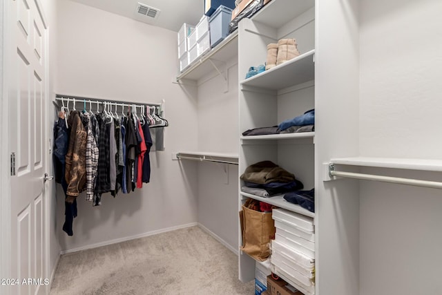 spacious closet featuring visible vents and light colored carpet