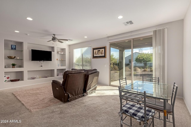 living area with built in shelves, visible vents, and a wealth of natural light