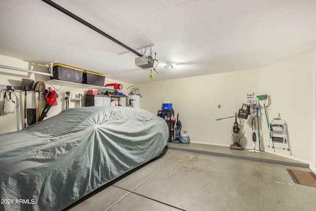 garage featuring a garage door opener and water heater