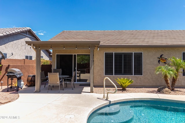 view of pool with a patio and area for grilling