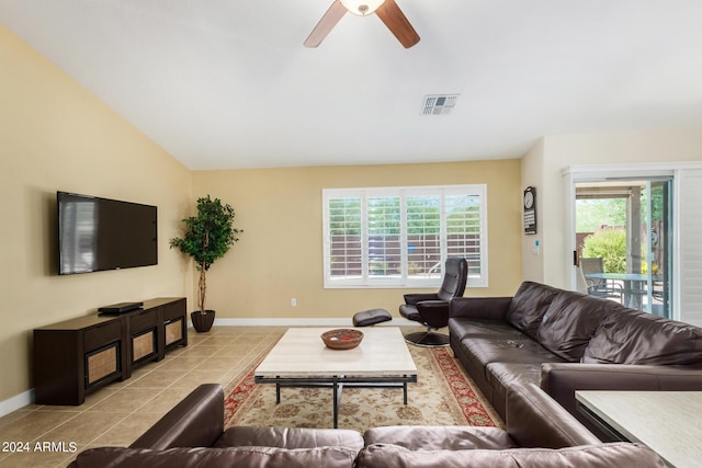 living room featuring ceiling fan, vaulted ceiling, a healthy amount of sunlight, and light tile patterned flooring