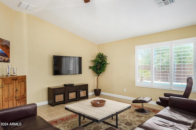 living room featuring lofted ceiling, light tile patterned floors, and a wealth of natural light