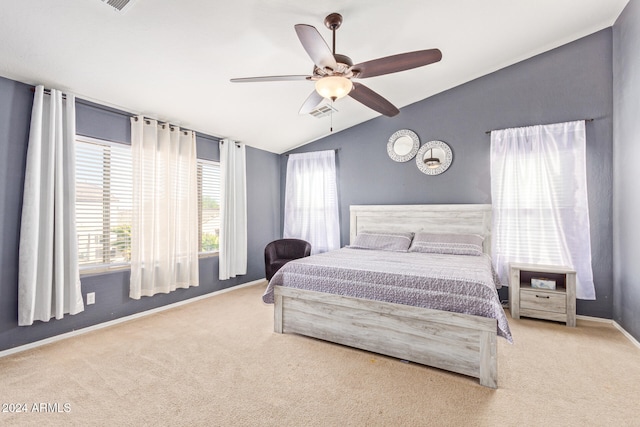 bedroom with ceiling fan, lofted ceiling, and light carpet