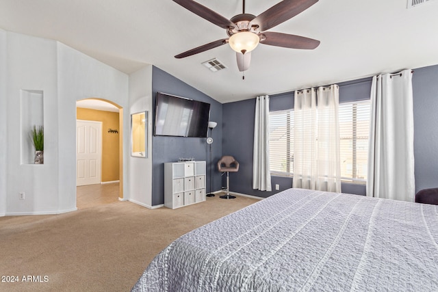 bedroom with ceiling fan, lofted ceiling, and carpet floors