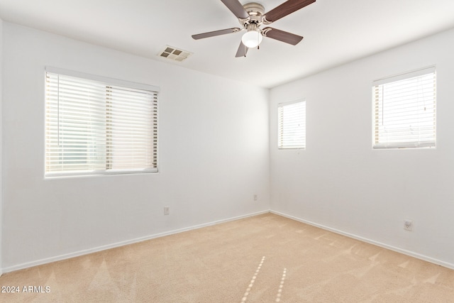 carpeted empty room featuring ceiling fan