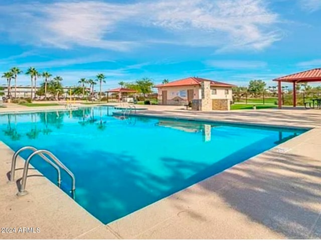 view of swimming pool with a gazebo and a patio area