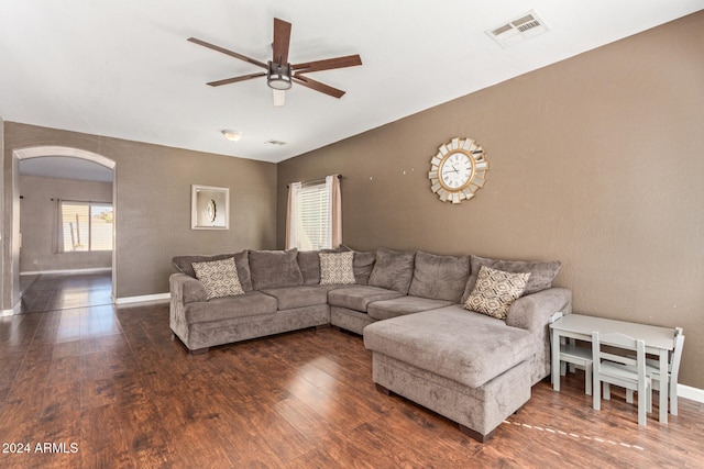 living room with dark hardwood / wood-style floors and ceiling fan