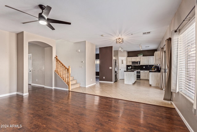 unfurnished living room featuring ceiling fan and light hardwood / wood-style flooring