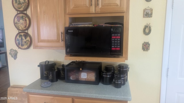 962 S Main Dr, Apache Junction, AZ 85120 - detailed view of black microwave and light brown cabinets