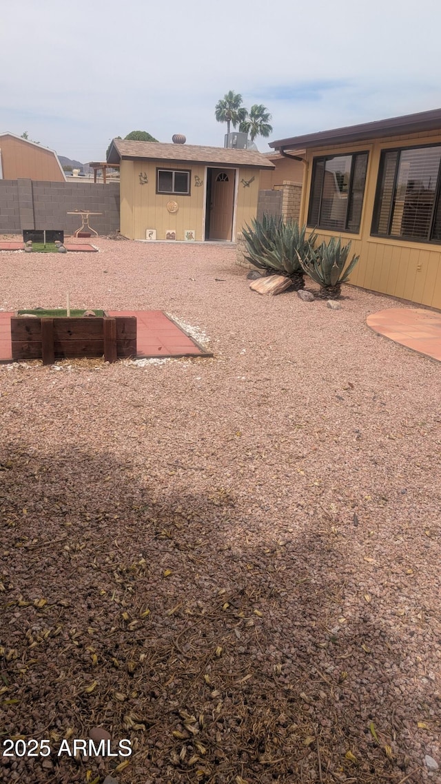 962 S Main Dr, Apache Junction, AZ 85120 - view of yard featuring fence and an outbuilding