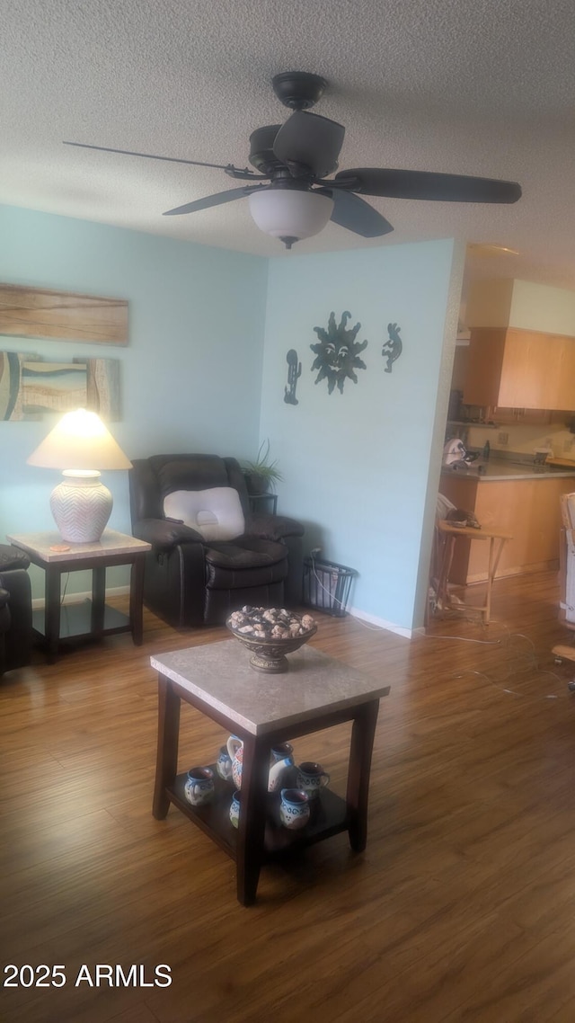 962 S Main Dr, Apache Junction, AZ 85120 - living area featuring wood finished floors, ceiling fan, and a textured ceiling
