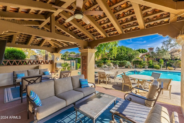 view of patio with a gazebo, ceiling fan, a community pool, and an outdoor hangout area