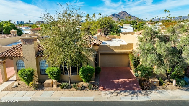 view of front facade with a mountain view and a garage