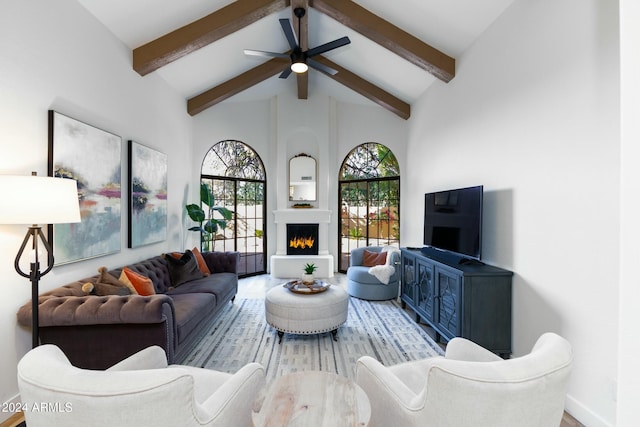 living room featuring beam ceiling, high vaulted ceiling, ceiling fan, and wood-type flooring