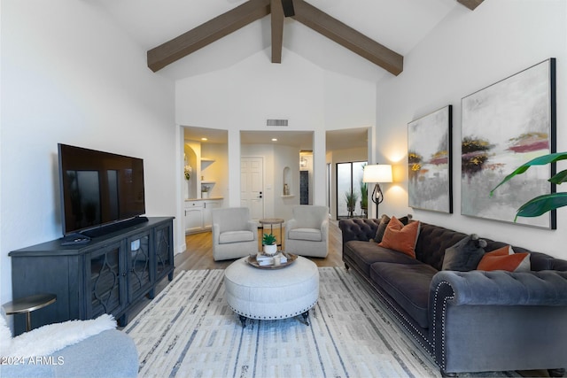 living room featuring beamed ceiling, light hardwood / wood-style floors, and high vaulted ceiling