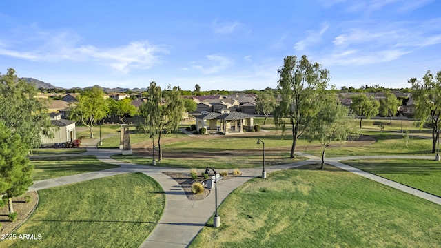 view of property's community featuring a residential view and a lawn