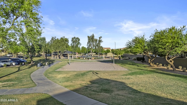 view of property's community featuring a lawn and volleyball court