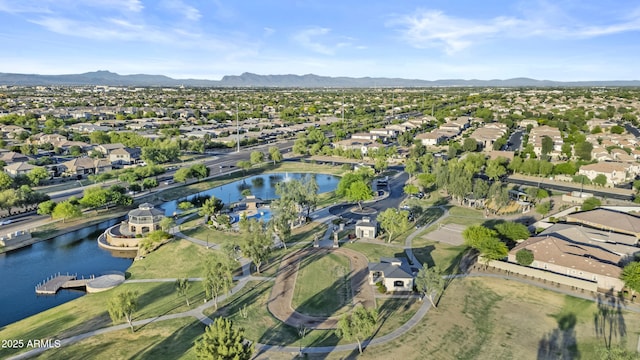 drone / aerial view featuring a water and mountain view and a residential view